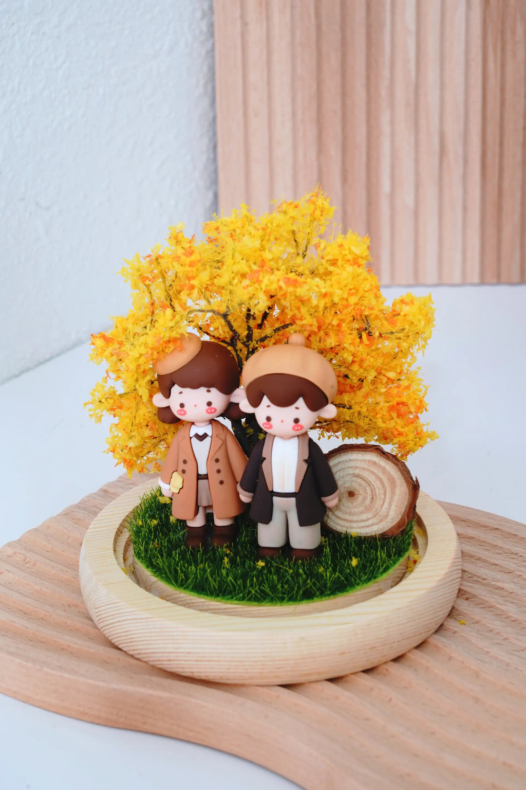 Autumn Love crystal ball with round glass dome removed showing couple miniatures and wooden base, LED lights off