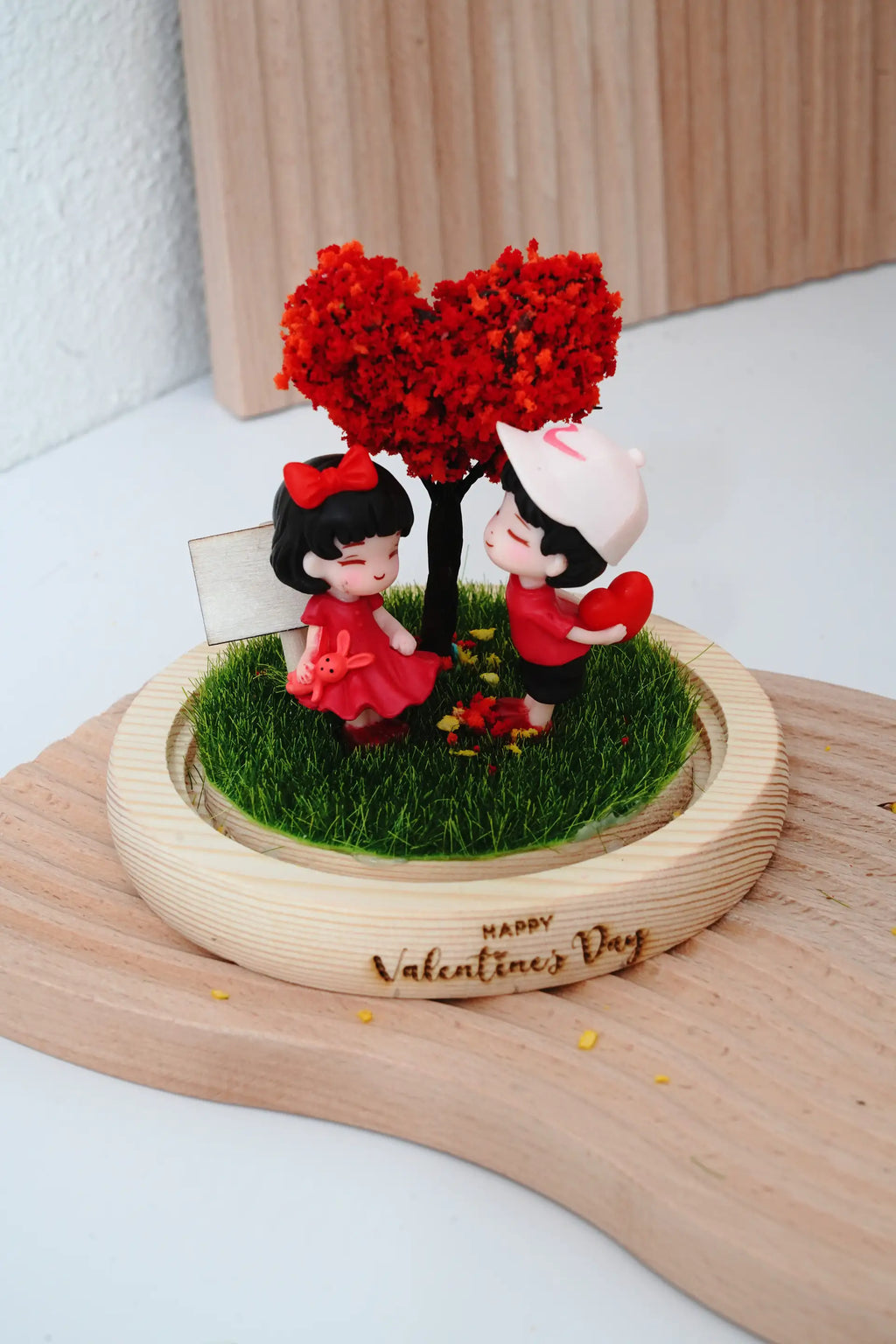 Valentine's crystal ball with round glass dome removed showing couple miniatures and heart tree design, wooden signboard and engraved base visible