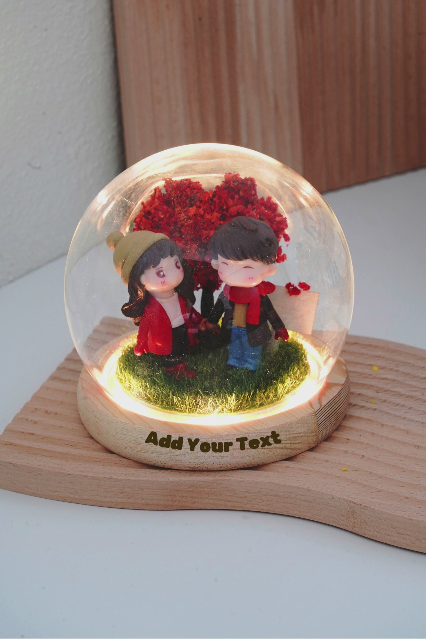 Demonstration video with animated text showing where to add custom text engraving on the wooden base and signboard inside the round glass dome