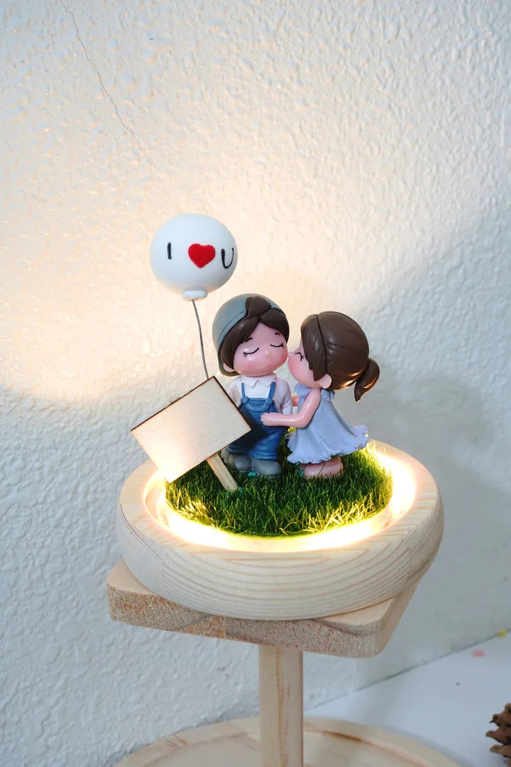 Decorative scene with a couple under a 'I ❤️ U' balloon on a white background
